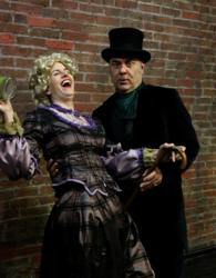 Kittson O'Neill and Paul L.Nolanas Mrs. Bob Cratchit and Ebeneezer Scrooge in MRS.BOB CRATCHIT's WILD CHRISTMAS BINGE.